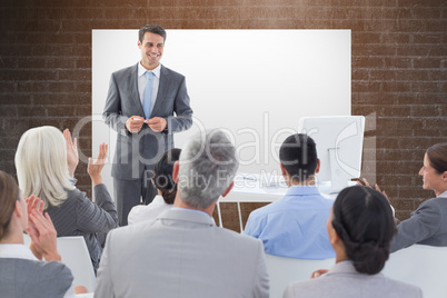 Composite image of businessman doing speech during meeting