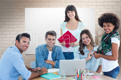 Composite image of smiling casual colleagues in a meeting