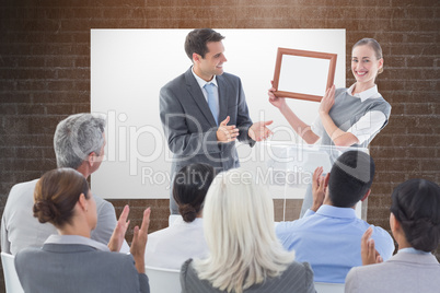 Composite image of business people receiving award