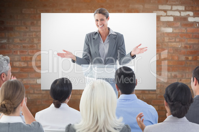 Composite image of businesswoman doing speech during meeting