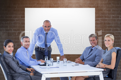 Composite image of happy business people looking at camera