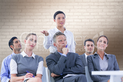 Composite image of business team during a meeting