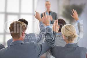 Composite image of business team raising hands during conference