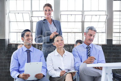 Composite image of business team taking a note during a meeting