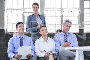 Composite image of business team taking a note during a meeting