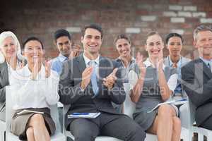 Composite image of business people applauding during meeting