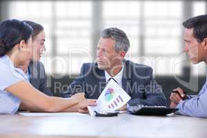 Composite image of  businessman meeting with colleagues using laptop