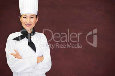 Composite image of portrait of smiling female cook in kitchen