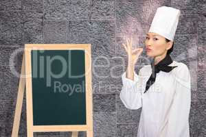 Composite image of smiling female cook in the kitchen