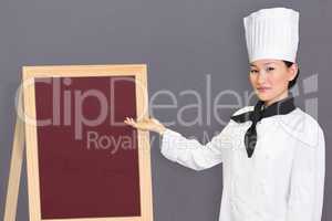 Composite image of confident female cook in the kitchen
