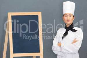 Composite image of portrait of confident female cook in kitchen