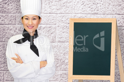 Composite image of portrait of smiling female cook in kitchen