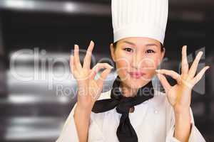 Composite image of closeup of a smiling female cook gesturing okay sign