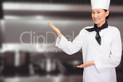 Composite image of portrait of a smiling female cook in kitchen