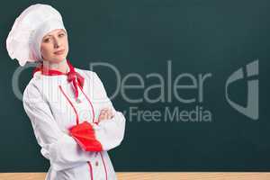 Composite image of pretty chef standing with arms crossed