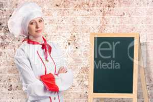 Composite image of pretty chef standing with arms crossed