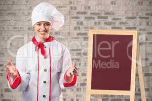 Composite image of pretty chef standing with hands out
