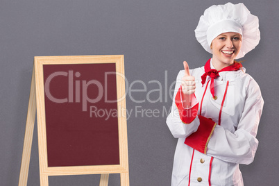 Composite image of pretty chef showing thumbs up