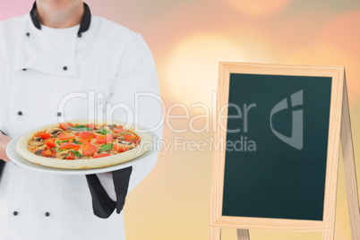 Composite image of male chef offering pizza