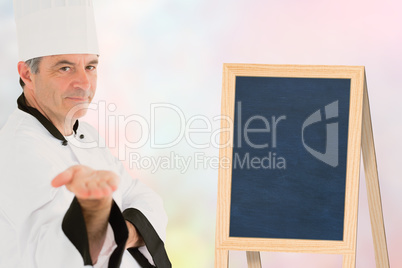 Composite image of male chef presenting an invisible product