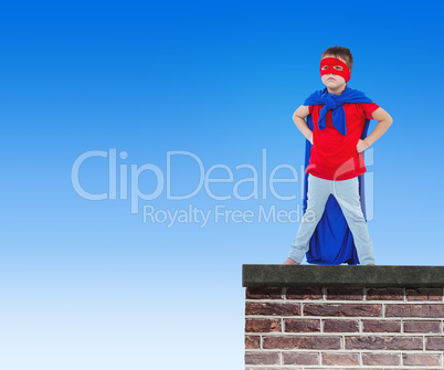 Composite image of masked boy pretending to be superhero