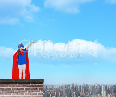 Composite image of masked girl pretending to be superhero