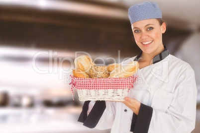 Composite image of woman in chef uniform with bread basket