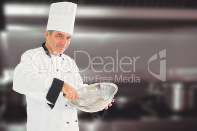 Composite image of mature chef using whisk and mixing bowl