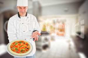 Composite image of chef displaying delicious pizza