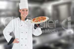 Composite image of confident female chef holding pizza