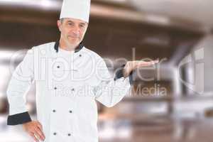 Composite image of mature chef displaying invisible product
