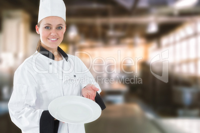 Composite image of young woman in chef uniform showing an empty plate