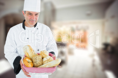 Composite image of man in chef uniform with bread basket