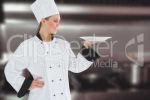 Composite image of female chef looking at plate