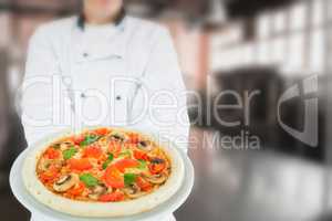 Composite image of chef holding delicious pizza