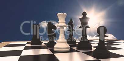 Composite image of white queen standing with black chess pieces