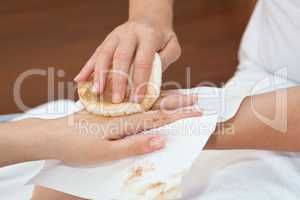 Therapist removing skin mask from the client's hand