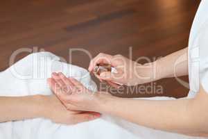 Hand massage, therapist applying softening tonic
