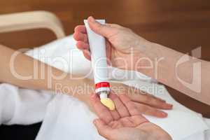 Hand treatment, therapist applying hand cream