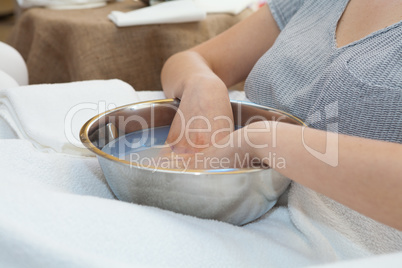 Soaking hands in warm water with softening bath before the hand