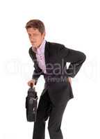 Businessman walking with back pain.