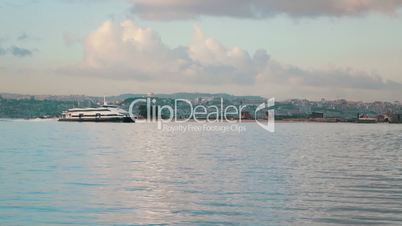 Ferry-Catamaran Sails on a Background of the City, Portugal