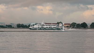 Ferry-Catamaran Sails on a Background of the City, Portugal