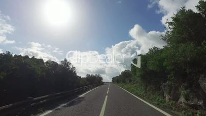 Driving on a Narrow Road in Mountains, sunny weather