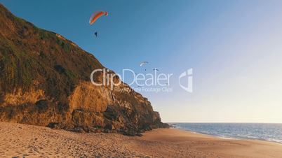 Paragliders Fly Over the Ocean Beach, sunny day