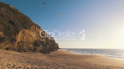 Paragliders Fly Over the Ocean Beach, sunny day