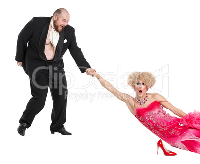 Eccentric Fat Man Dragging a Woman by the Hand Lying on Floor