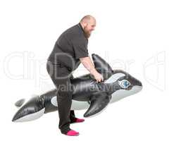 Fat Man Fun Jumping on an Inflatable Dolphin