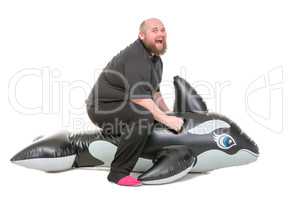 Fat Man Fun Jumping on an Inflatable Dolphin