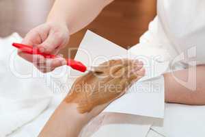 Therapist applying nourishing mask on woman's hand